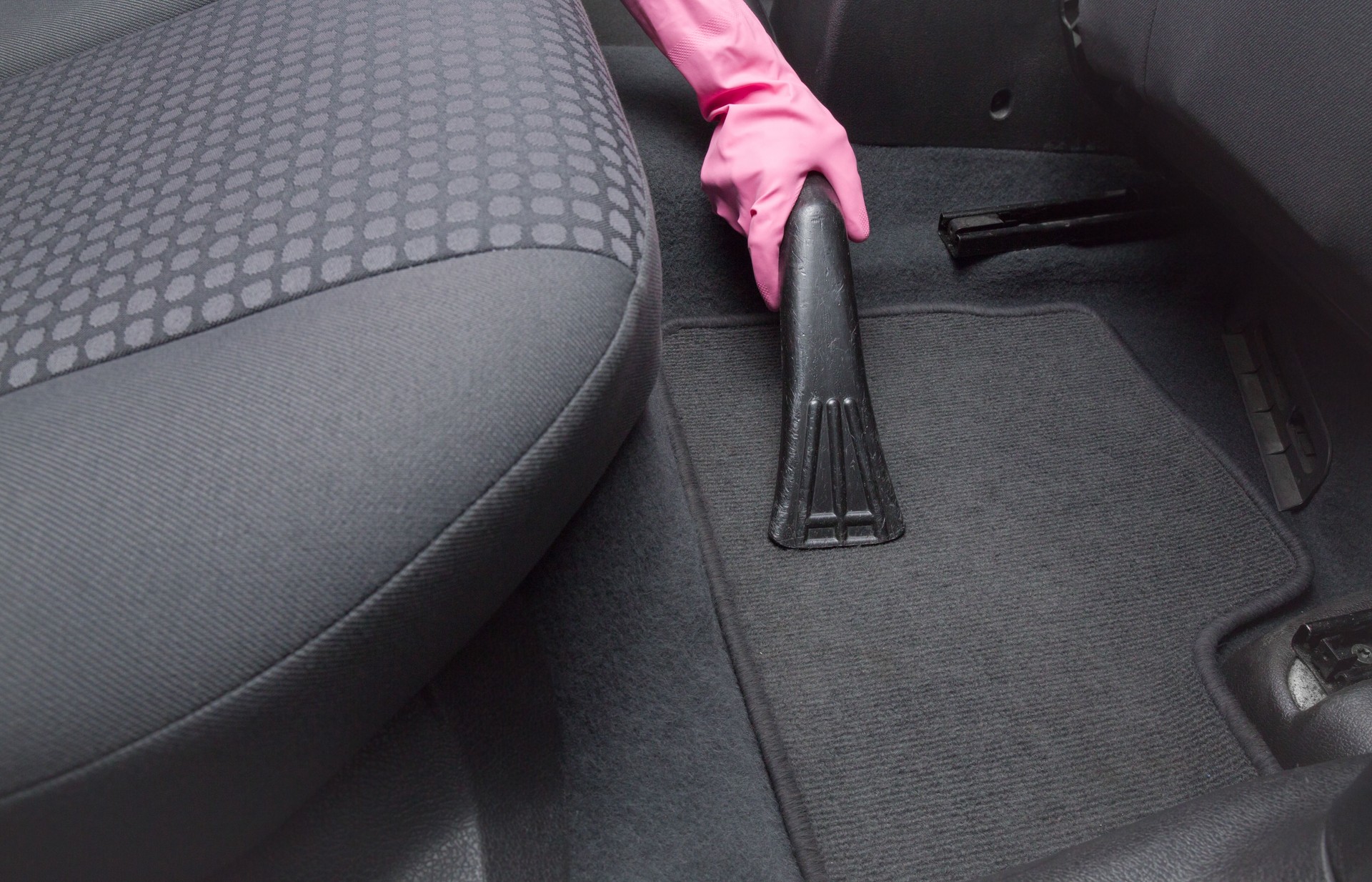 Before chemical cleaning process a professionally nozzle releasing car floor from dust and sand. Early spring cleaning or regular clean up.